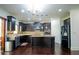 Modern kitchen with dark wood cabinets, stainless steel appliances, and a center island at 4750 Sabino Bnd, Cumming, GA 30040