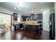 Modern kitchen with dark wood cabinets, stainless steel appliances, and a center island at 4750 Sabino Bnd, Cumming, GA 30040