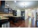 Modern kitchen with dark wood cabinets, stainless steel appliances, and a center island at 4750 Sabino Bnd, Cumming, GA 30040