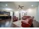 Spacious living room with hardwood floors, leather furniture, and an open floor plan at 4750 Sabino Bnd, Cumming, GA 30040