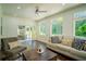 Bright living room with a comfortable sofa and chair, large windows, and sliding door to patio at 4750 Sabino Bnd, Cumming, GA 30040