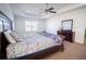 Spacious main bedroom featuring a ceiling fan, carpet, and a large window at 4750 Sabino Bnd, Cumming, GA 30040