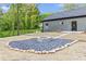 Landscaped backyard featuring a custom-built fire pit and a relaxing outdoor space at 60 Wheeler Lake Path, Dallas, GA 30157