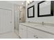 Bathroom with white vanity, framed mirrors and a walk-in shower at 60 Wheeler Lake Path, Dallas, GA 30157