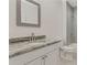 Updated bathroom with a marble vanity top, white cabinets, and a tile shower/tub combo at 60 Wheeler Lake Path, Dallas, GA 30157