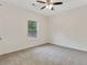 Bedroom with a ceiling fan and large window offering ample natural light at 60 Wheeler Lake Path, Dallas, GA 30157