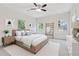 Bright bedroom features a ceiling fan, a cozy bed with a white cover, and a decorative wooden ladder at 60 Wheeler Lake Path, Dallas, GA 30157