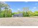 Charming single-story home with a well-manicured lawn and a backdrop of lush trees at 60 Wheeler Lake Path, Dallas, GA 30157