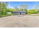 Backyard view of cozy home surrounded by lush greenery and an expansive lawn area at 60 Wheeler Lake Path, Dallas, GA 30157