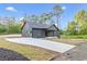 New home boasting a long driveway, modern design, gray siding, and well manicured lawn at 60 Wheeler Lake Path, Dallas, GA 30157