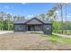 Charming single-story home with a modern gray facade, well-manicured lawn, and inviting front porch at 60 Wheeler Lake Path, Dallas, GA 30157