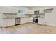 Bright kitchen featuring stainless steel appliances, white cabinets, granite countertops, and tile backsplash at 60 Wheeler Lake Path, Dallas, GA 30157