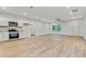 Bright open-concept living space with hardwood floors, a ceiling fan, and plenty of natural light at 60 Wheeler Lake Path, Dallas, GA 30157