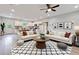 Open-concept living room featuring a modern ceiling fan, stylish rug and comfortable seating at 60 Wheeler Lake Path, Dallas, GA 30157