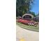Entrance to Brooks Village, featuring colorful flowerbed landscaping and stone monument sign at 1316 Village Brook Dr, Dacula, GA 30019