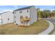 Two-story home featuring a wooden deck and a well-maintained lawn on a sunny day at 1316 Village Brook Dr, Dacula, GA 30019