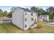 Backyard view of a two-story home, featuring a wooden deck and a well-maintained lawn at 1316 Village Brook Drive, Dacula, GA 30019