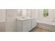 Bathroom featuring double sink vanity, tub, and a window for natural light at 1316 Village Brook Drive, Dacula, GA 30019