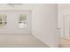 Bright bedroom featuring large windows with a view and neutral carpet, creating a serene retreat at 1316 Village Brook Drive, Dacula, GA 30019