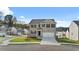 A charming two-story home features a well-maintained lawn, a driveway, and classic curb appeal in a suburban neighborhood at 1316 Village Brook Drive, Dacula, GA 30019