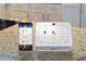 Smart home security system displays thermostat, security, and video options on a digital interface at 1316 Village Brook Drive, Dacula, GA 30019