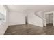 Bright living room with hardwood floors, a ceiling fan, and a staircase at 1316 Village Brook Drive, Dacula, GA 30019