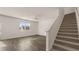 Bright living room featuring hardwood floors, a ceiling fan, and a staircase at 1316 Village Brook Drive, Dacula, GA 30019