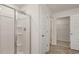 Modern shower featuring glass door and tiled walls adjacent to the doorway leading to the walk-in closet at 1316 Village Brook Drive, Dacula, GA 30019