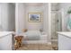 Bright bathroom featuring a soaking tub, glass shower, tile floors, and white cabinets at 2000 Suttles Sw Dr, Atlanta, GA 30331