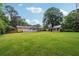 Expansive backyard with lush green lawn, shed, and deck ideal for outdoor enjoyment at 4125 Hickory Dr, Powder Springs, GA 30127