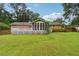 Spacious backyard features a large deck, screened porch, and mature trees for optimal privacy at 4125 Hickory Dr, Powder Springs, GA 30127
