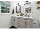 Bright bathroom features a double sink vanity with granite counters, modern fixtures, and updated lighting at 4125 Hickory Dr, Powder Springs, GA 30127