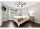 This stylish bedroom includes hardwood floors, a ceiling fan, and a large window allowing natural light at 4125 Hickory Dr, Powder Springs, GA 30127