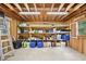 Spacious garage with wood-framed walls and ceiling, shelving units and concrete floor provide ample storage at 4125 Hickory Dr, Powder Springs, GA 30127
