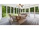 Screened porch with modern furniture and an overhead fan is a perfect spot for relaxation at 4125 Hickory Dr, Powder Springs, GA 30127