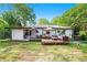 Spacious backyard featuring a large wooden deck, patio furniture, and lawn at 4128 Morgan Rd, Tucker, GA 30084