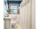 Bathroom featuring a shower and window, with a white vanity sink and toilet at 4128 Morgan Rd, Tucker, GA 30084