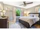 Bedroom featuring a ceiling fan, large window, and hardwood flooring at 4128 Morgan Rd, Tucker, GA 30084