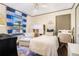 Bright bedroom featuring a single bed, chair, and a window with stylish blue striped curtains at 4128 Morgan Rd, Tucker, GA 30084