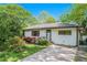 Charming single-story home featuring a well-maintained lawn and vibrant red flowers at 4128 Morgan Rd, Tucker, GA 30084