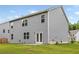 View of the back exterior of the home showcasing gray siding and a well-maintained lawn at 4827 Golden Finch Ln, Powder Springs, GA 30127