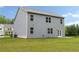 Spacious backyard featuring a two-story house with gray siding, and a green lush lawn at 4827 Golden Finch Ln, Powder Springs, GA 30127
