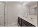 This bathroom offers a double sink, neutral walls, vinyl floors, and plenty of space for storage at 4827 Golden Finch Ln, Powder Springs, GA 30127