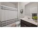 Cozy bathroom featuring a shower-tub combination with a white-and-gray curtain, toilet, and modern sink at 4827 Golden Finch Ln, Powder Springs, GA 30127