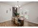 Dining area with wood floors, stylish light fixture, and access to the backyard at 4827 Golden Finch Ln, Powder Springs, GA 30127