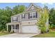 Charming two-story home features gray siding, brick accents, and a two-car garage at 4827 Golden Finch Ln, Powder Springs, GA 30127