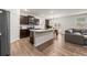 Open-concept kitchen features dark cabinetry, a center island, and stainless steel appliances at 4827 Golden Finch Ln, Powder Springs, GA 30127