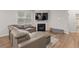 Comfortable living room features a gray sectional sofa, fireplace, and large screen television above the mantel at 4827 Golden Finch Ln, Powder Springs, GA 30127
