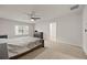 Neutral toned main bedroom featuring a large bed, ceiling fan, dresser, and access to an ensuite bathroom at 4827 Golden Finch Ln, Powder Springs, GA 30127