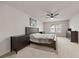 Spacious main bedroom with large bed, dark wood furniture, and ceiling fan in a neutral color palette at 4827 Golden Finch Ln, Powder Springs, GA 30127